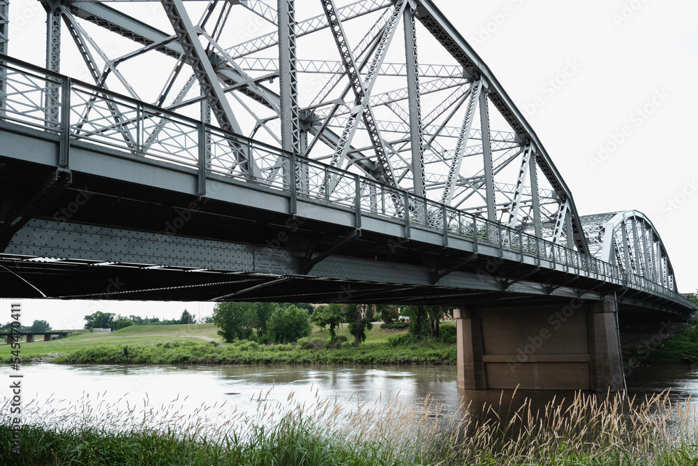 Rustic metal bridge over the river, partial view close-up Rustic metal bridge over the river, partial view close-up
