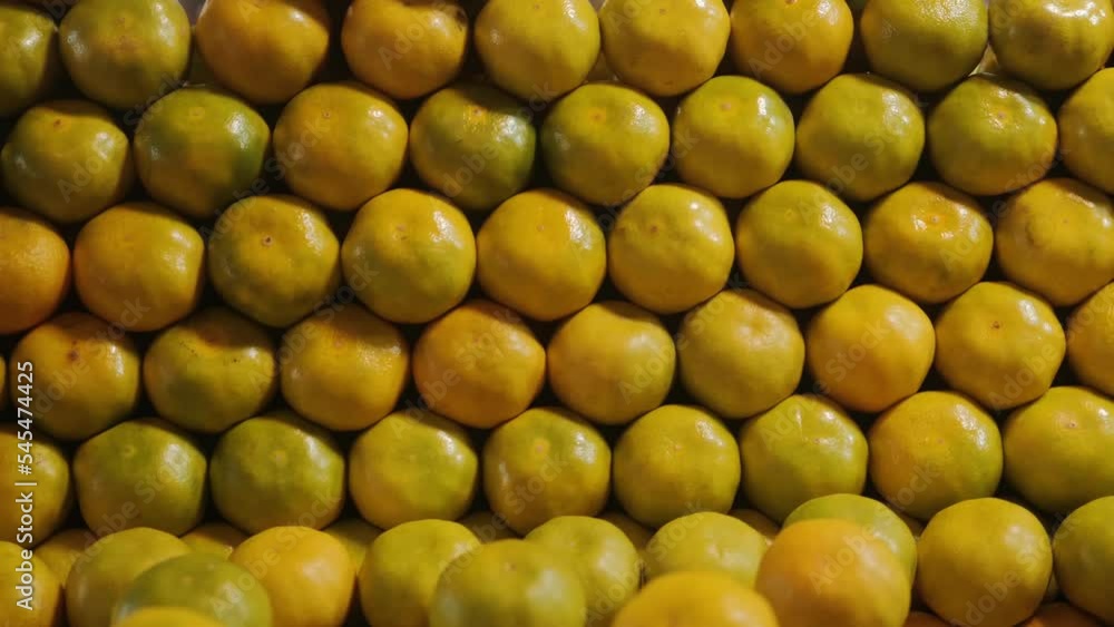 Tangerines at the farmer's market are laid out flat on the counter. Beautiful background of tangerines at the farmer's market. Healthy ecological farm products. High quality 4k footage Tangerines at the farmer's market are laid out flat on the counter. Beautiful background of tangerines at the farmer's market. Healthy ecological farm products. High quality 4k footage