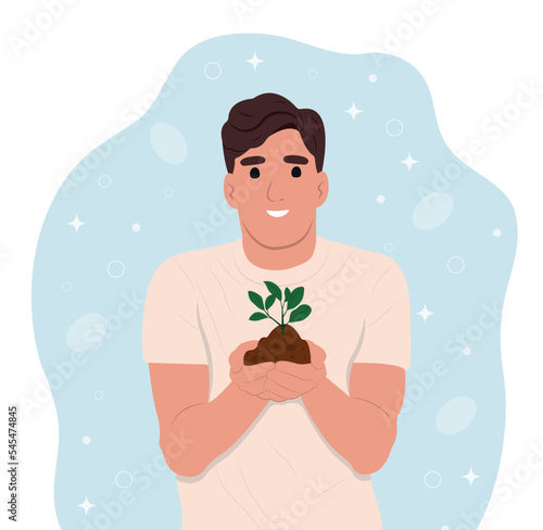 World Soil Day is held annually on December 5. The man is holding a green plant in her hands. Forest restoration, reforestation planting trees, environment day.