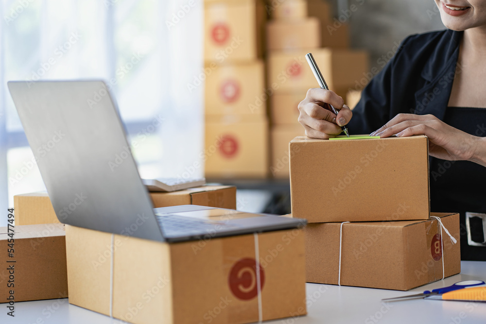 SME Business Entrepreneur Working From Home With Parcel Boxes And Laptop Taking Orders And Shipping Online Grocery Business Ideas SME Business Entrepreneur Working From Home With Parcel Boxes And Laptop Taking Orders And Shipping Online Grocery Business Ideas