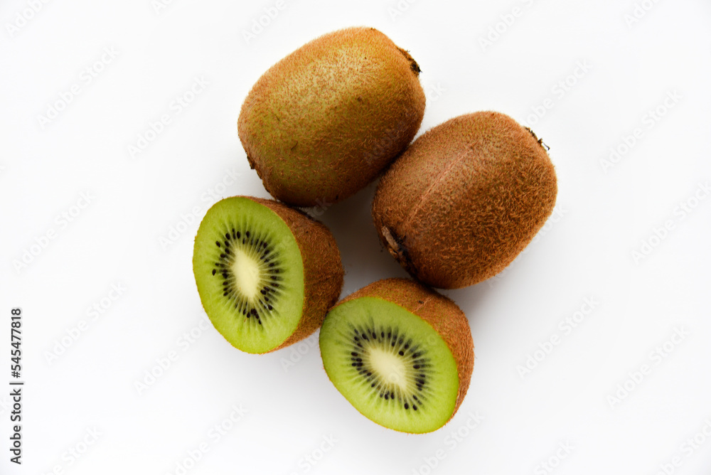 Chopped fruit of green juicy kiwi on a white background. Delicious kiwi slices close-up. Chopped fruit of green juicy kiwi on a white background. Delicious kiwi slices close-up.