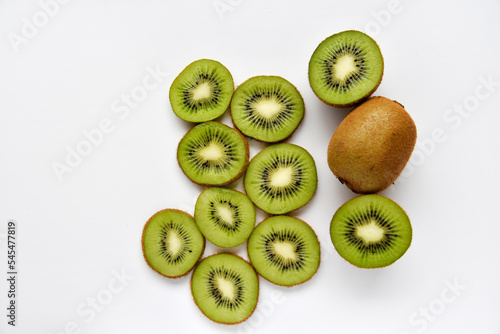 Chopped fruit of green juicy kiwi on a white background. Delicious kiwi slices close-up.