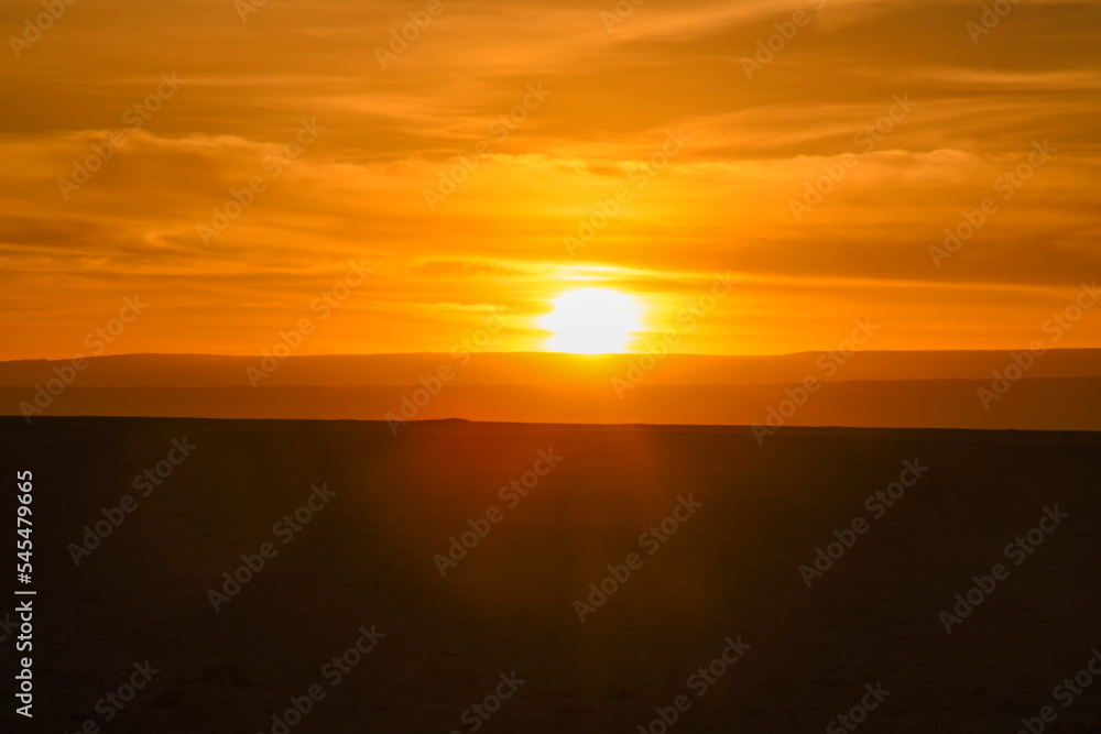 Desert sunset with warm light on the dunes. Atacama desert, Chile.