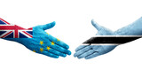 Handshake between Tuvalu and Botswana flags painted on hands, isolated transparent image.