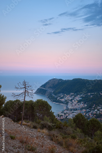 Summer view of the coastal town on the Italian Riviera from the mountain at sunset. Laigueglia town on Italian Riviera, Liguria, Italy