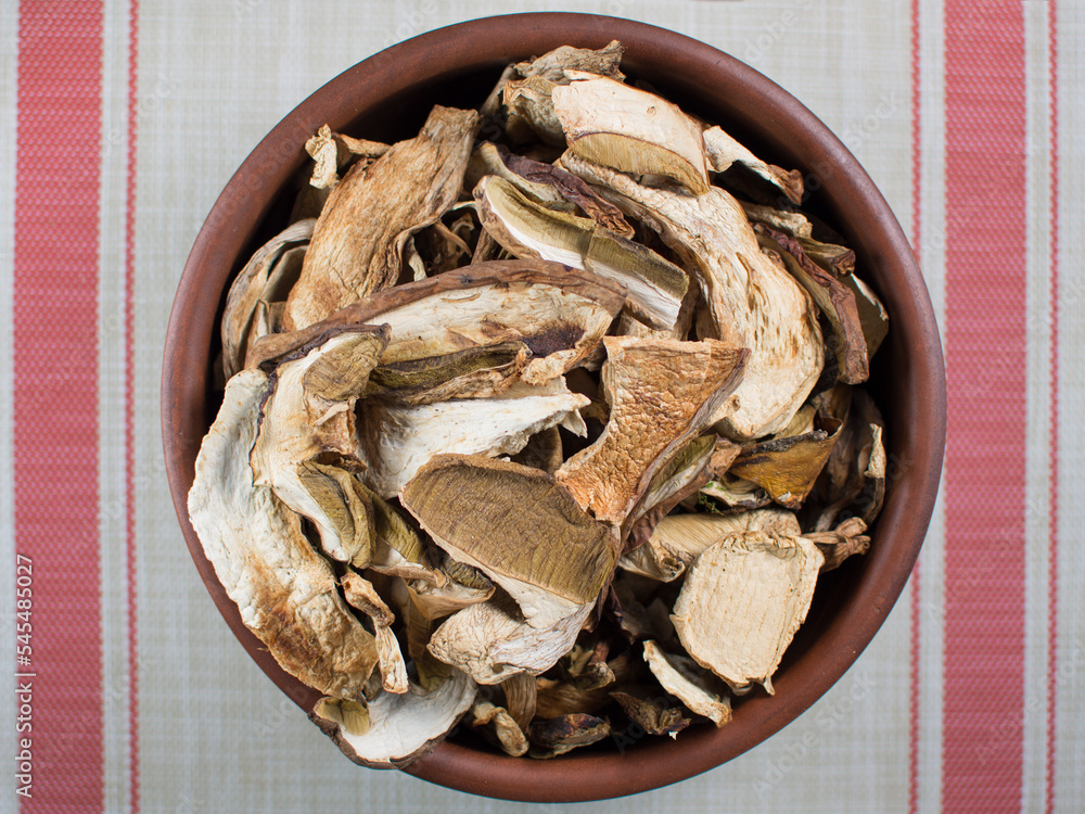 Dry mushrooms (Boletus edulis) on the table, top view. Gourmet dishes of porcini mushrooms. Dry mushrooms (Boletus edulis) on the table, top view. Gourmet dishes of porcini mushrooms.