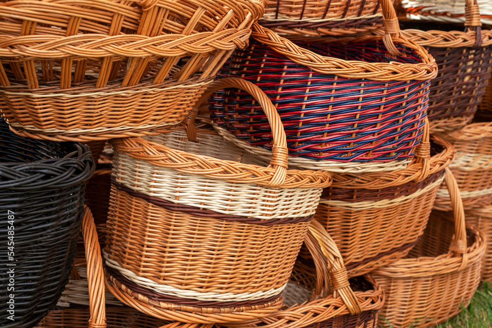 Stack of different-shaped wicker baskets. The handmade DIY baskets on the street market