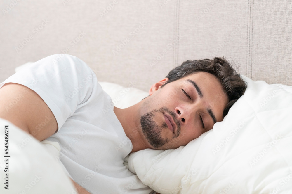 Young handsome man sleeping in the bed at the early morning Young handsome man sleeping in the bed at the early morning
