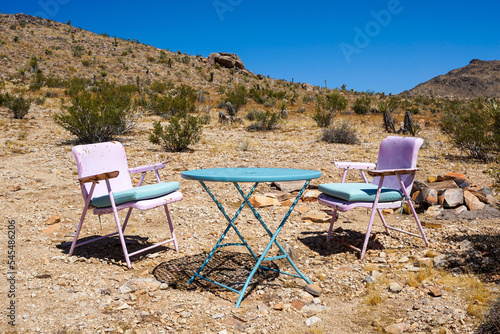 two chairs and a table in the desert