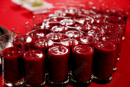 Glasses with pomegranate or tomatoes juice at some event. Banquet event
