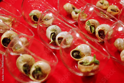 Escargots de Bourgogne. Stuffed baked snails with butter, herbs and garlic. French traditional food. Banquet event