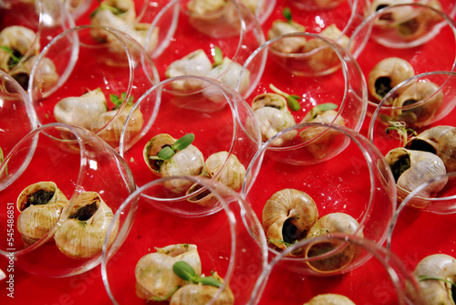 Escargots de Bourgogne. Stuffed baked snails with butter, herbs and garlic. French traditional food. Banquet event