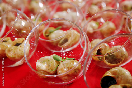 Escargots de Bourgogne. Stuffed baked snails with butter, herbs and garlic. French traditional food. Banquet event