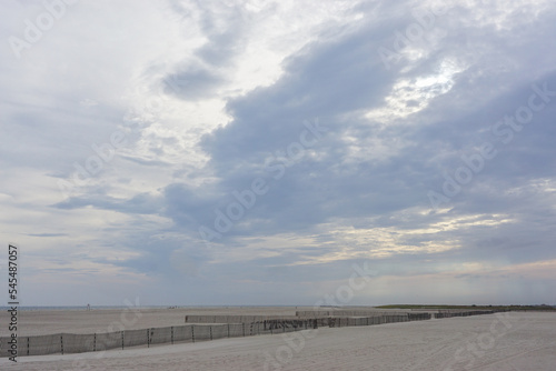 Jones Beach State Park, New York, USA: Fencing protects this Long Island beach from wind erosion as clouds gather over head at sunset.