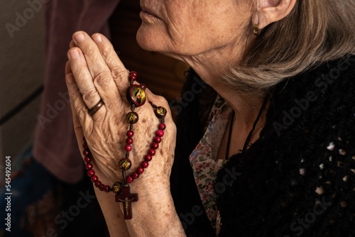 Grandmother praying to god (ID: 545492604)
