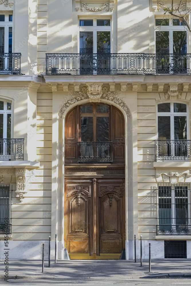 Paris, a wooden door, typical building in the 7th arrondissement, a luxury district
