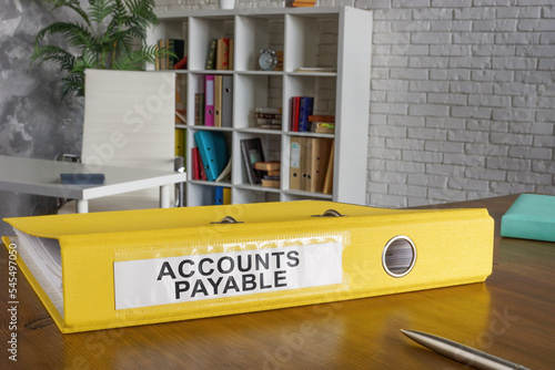 Yellow folder with label accounts payable on the table.