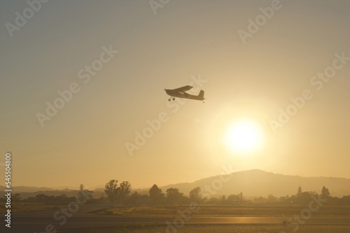 air travel warm sunset with airplane take off with mountain background 