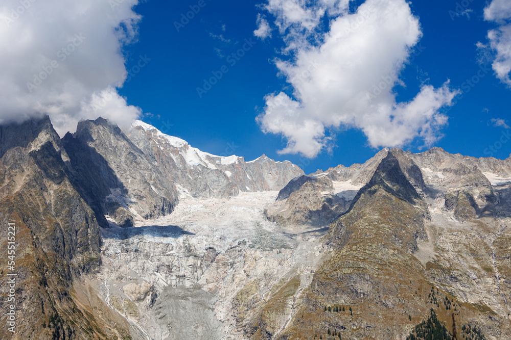 Monte Bianco Mountain Range of the Italian Alps on a Cloudy Summer Day- view of Glacier, Green Vegetation and Blue Sky