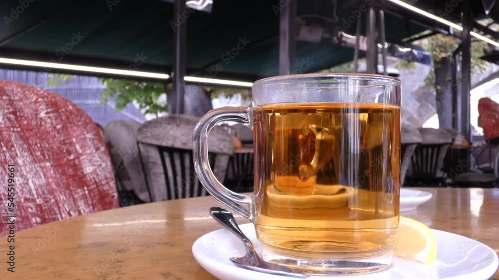 Freshly brewed black tea in a transparent glass Cup, escaping steam Freshly brewed black tea in a transparent glass Cup, escaping steam