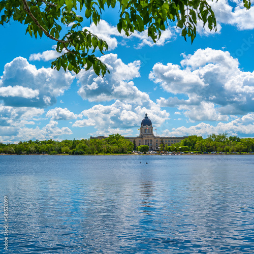Wascana Park panoramic landscape with lake, fountain and Saskatchewan Legislative Building in Regina Saskatchewan Canada