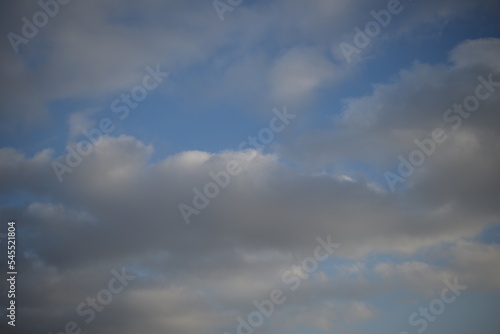 background of daytime cloudy sky white clouds rainy weather blue sky sun rays texture of sky and cirrus clouds in a city in Ukraine  atmosphere  peaceful sky stratosphere  before the rain 
