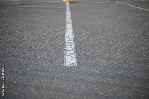 concrete traffic limiters, concrete tokens painted white, parking space, symmetrical lines on a concrete road, concrete hemispheres mounted on asphalt, concrete parking hemispheres, cones restricting 