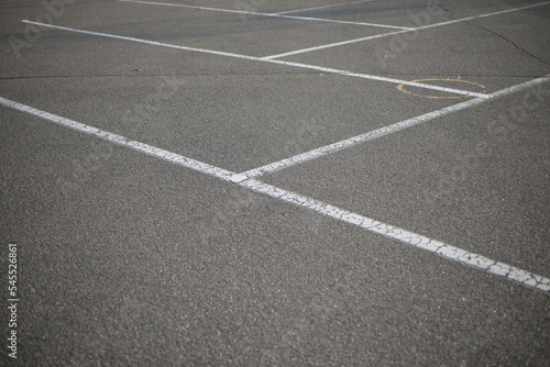 white lines abstract on asphalt, road markings white stripes on the asphalt road, parking spaces separated by white lines, symmetrical abstract lines on gray asphalt © Анна Климчук
