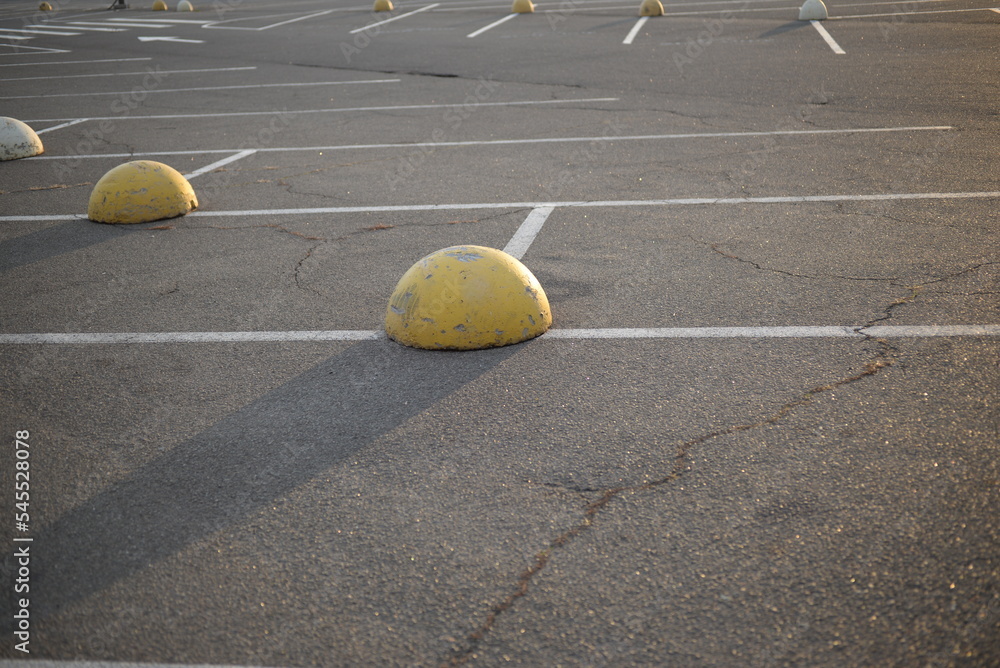 concrete traffic limiters concrete markers painted white, parking space