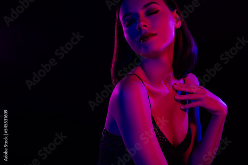 Passionate lady with closed eyes touch herself demonstrate night visage got wet from dancing isolated over dark lights