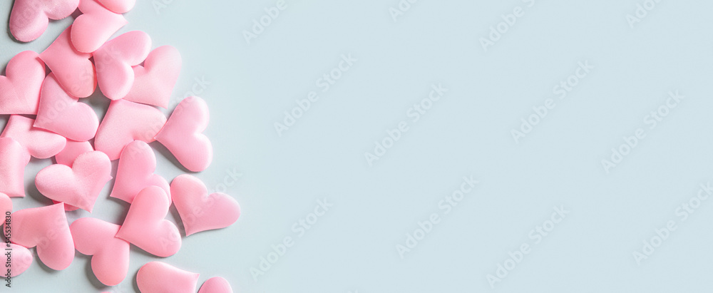 Frame of romantic pink hearts on blue background. Valentine's day greeting card with copy space. Love concept. Banner. Frame of romantic pink hearts on blue background. Valentine's day greeting card with copy space. Love concept. Banner.