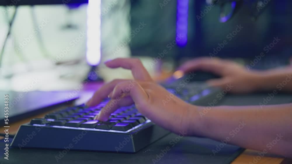 Close up of frustrated female gamer using computer keyboard and banging desks with fists when she loses - shot in slow motion Close up of frustrated female gamer using computer keyboard and banging desks with fists when she loses - shot in slow motion
