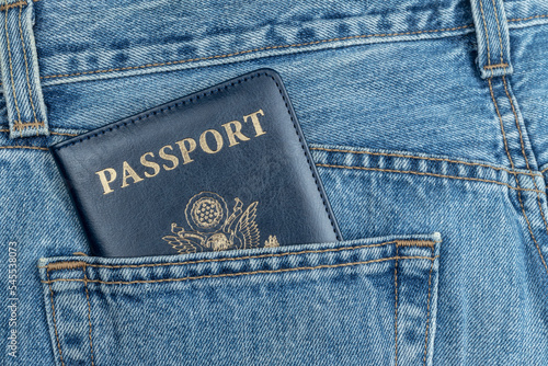 USA PASSPORT IN BLUE JEANS POCKET. TOURIST AND TRAVELER CONCEPT FROM UNITED STATES OF AMERICA.