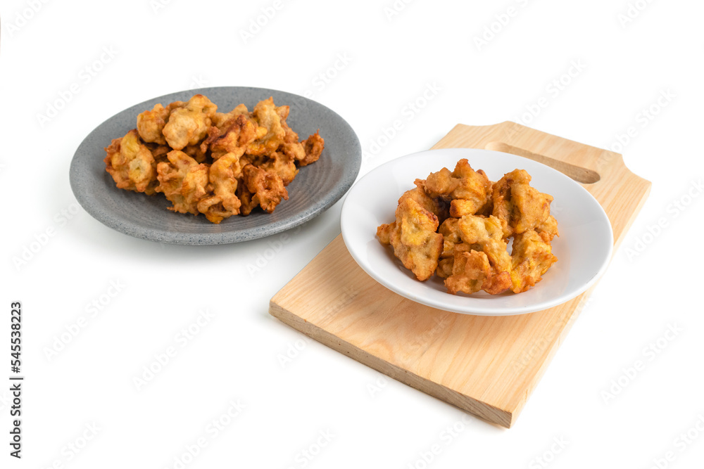 banana fritter or fried banana on a plate and wooden cutting board isolated on white background banana fritter or fried banana on a plate and wooden cutting board isolated on white background