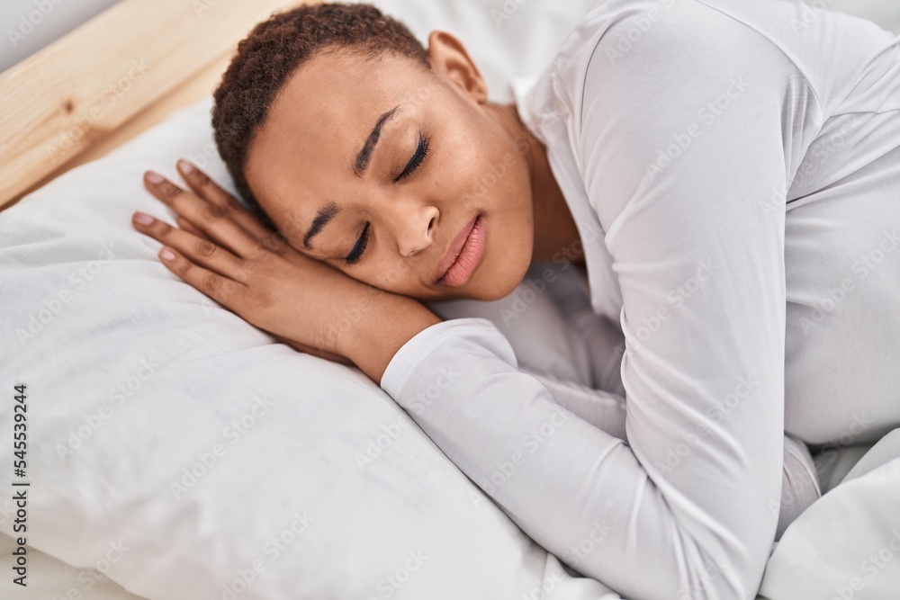 African american woman lying on bed sleeping at bedroom African american woman lying on bed sleeping at bedroom