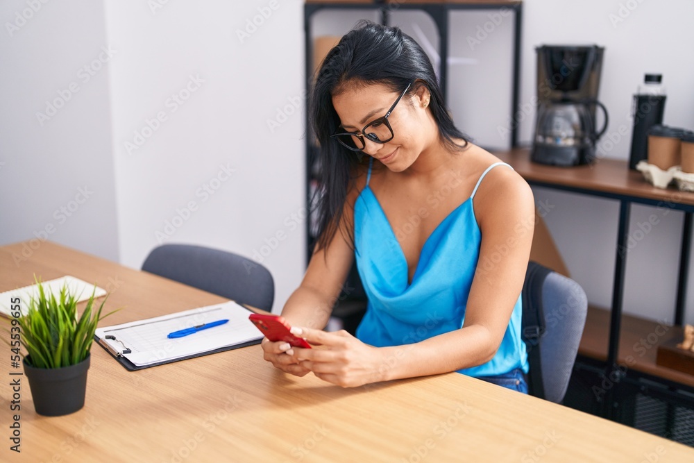 Young beautiful latin woman business worker using smartphone working at office Young beautiful latin woman business worker using smartphone working at office