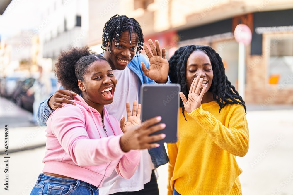 Obraz premium African american friends standing together having video call at street