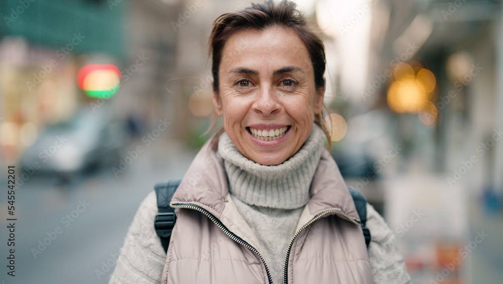 Fototapeta premium Middle age hispanic woman smiling confident standing at street