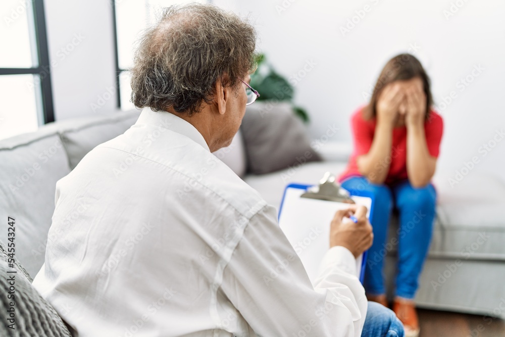 Fototapeta premium Middle age man and woman having psychology session at home