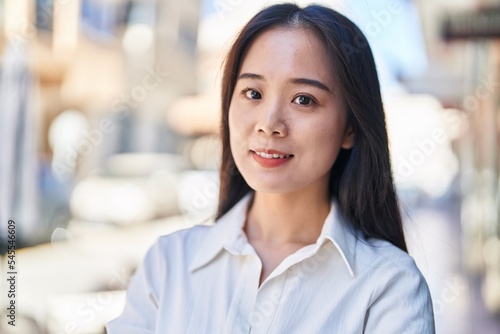 Young chinese woman smiling confident standing at street