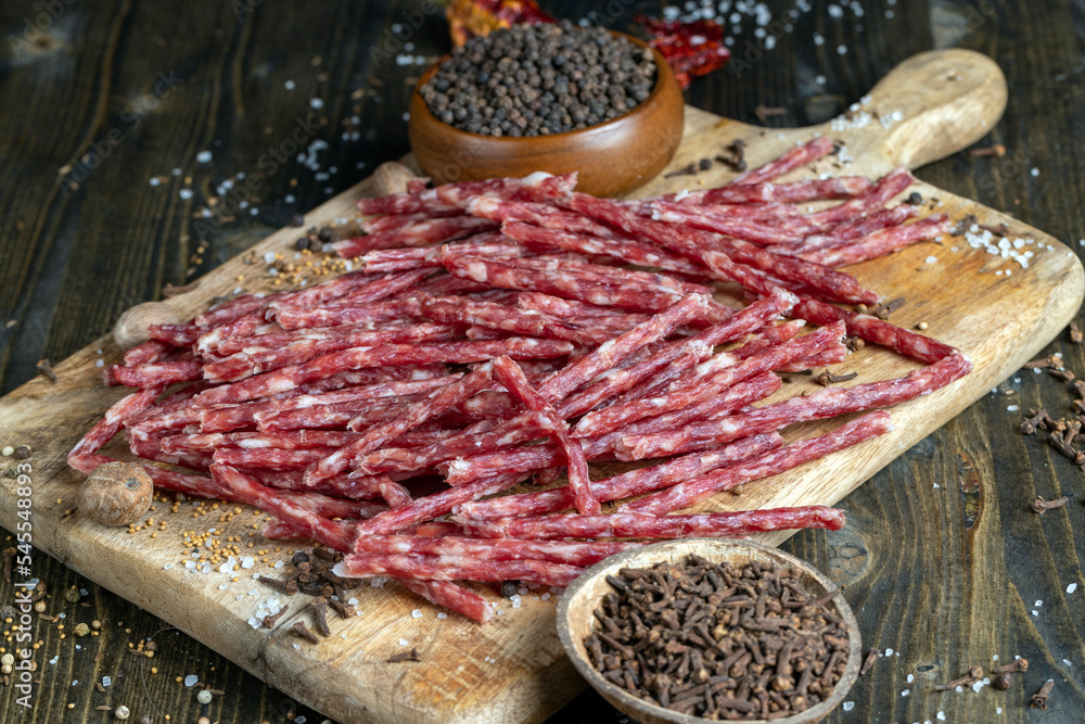 thin dried meat sausages with spices , close up