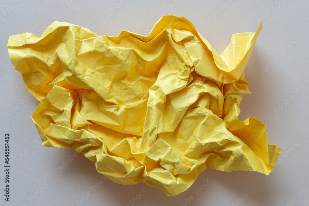 yellow paper crumpled into a ball and then slightly stretched back out yellow paper crumpled into a ball and then slightly stretched back out