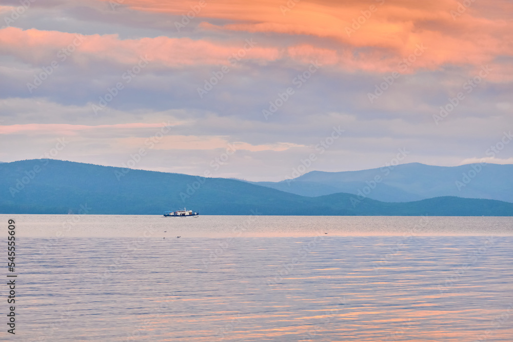 Kurbulik, Republic of Buryatia, Russia - July 11, 2022: A ship with tourists in the Chivyrkuysky Bay of Lake Baikal. Kurbulik, Republic of Buryatia, Russia - July 11, 2022: A ship with tourists in the Chivyrkuysky Bay of Lake Baikal.