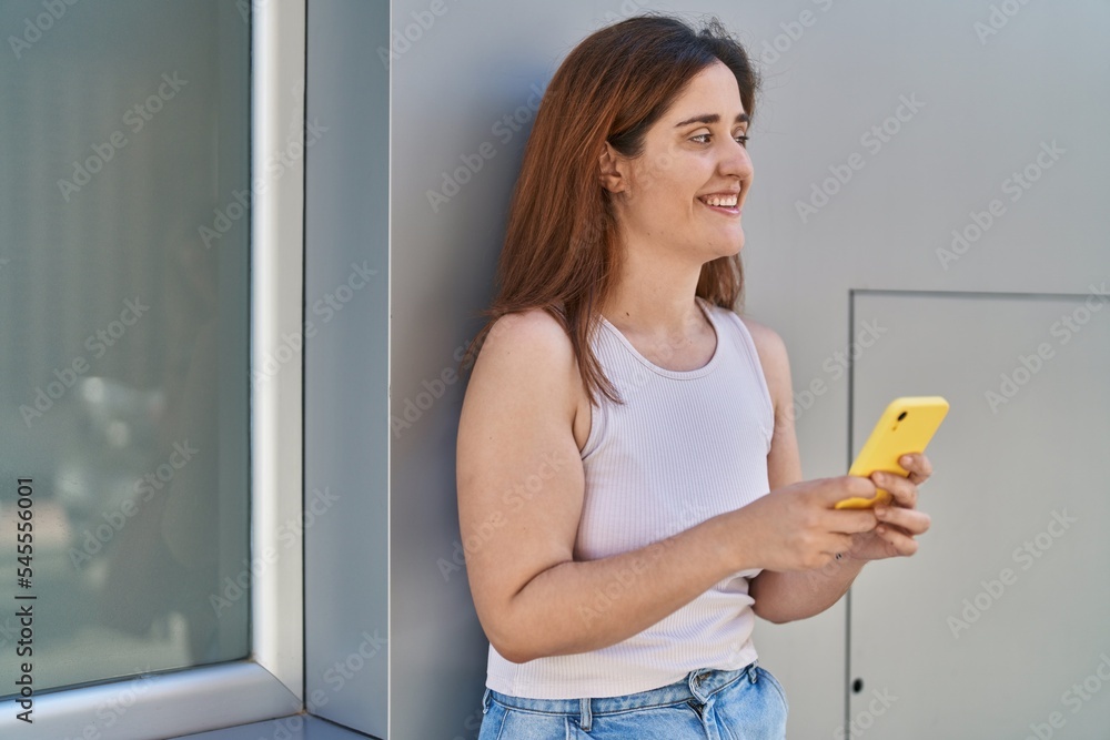 Young woman smiling confident using smartphone at street Young woman smiling confident using smartphone at street