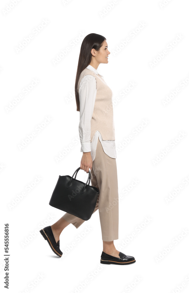 Young woman with stylish leather bag walking on white background Young woman with stylish leather bag walking on white background