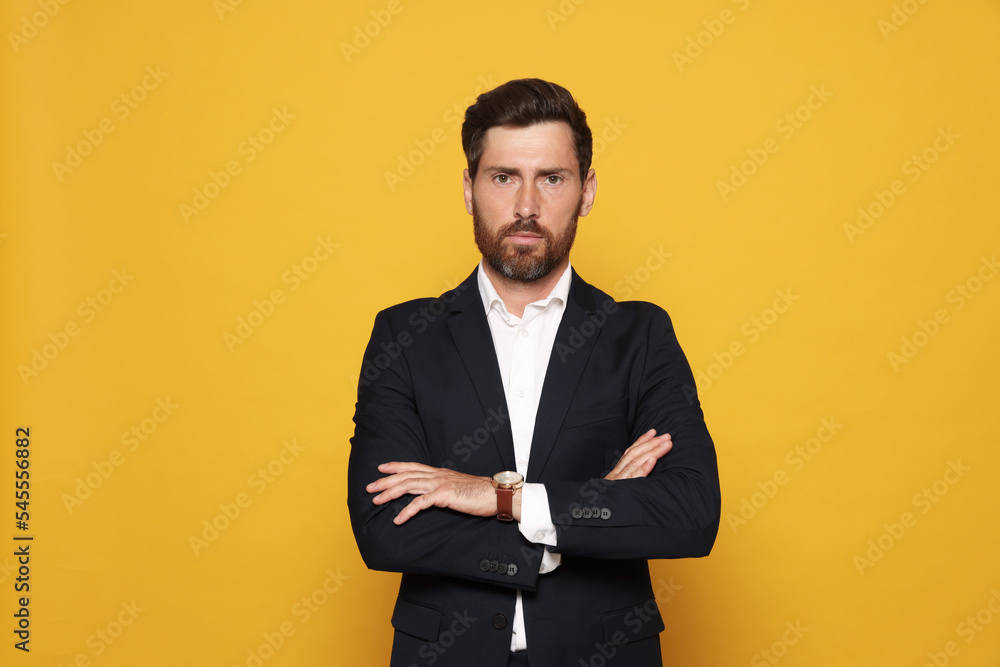 Portrait of bearded man in suit on orange background Portrait of bearded man in suit on orange background