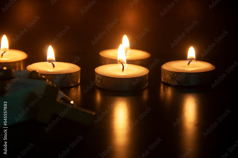 Candle lights and dark black background with customizable space for text or ideas. Copy space and Christian religion concept. Candle lights and dark black background with customizable space for text or ideas. Copy space and Christian religion concept.
