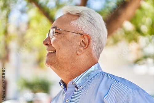 Senior man smiling confident standing at park