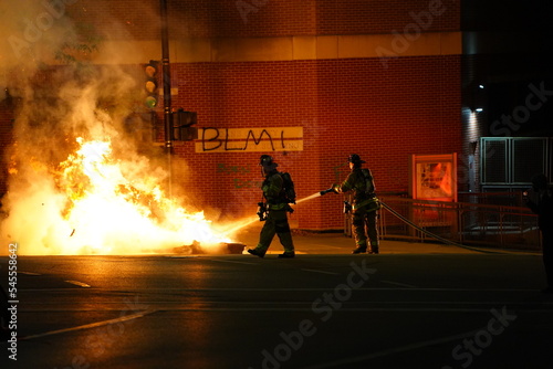 Firefighters putting out fires from jacob blake rioters burning the streets.