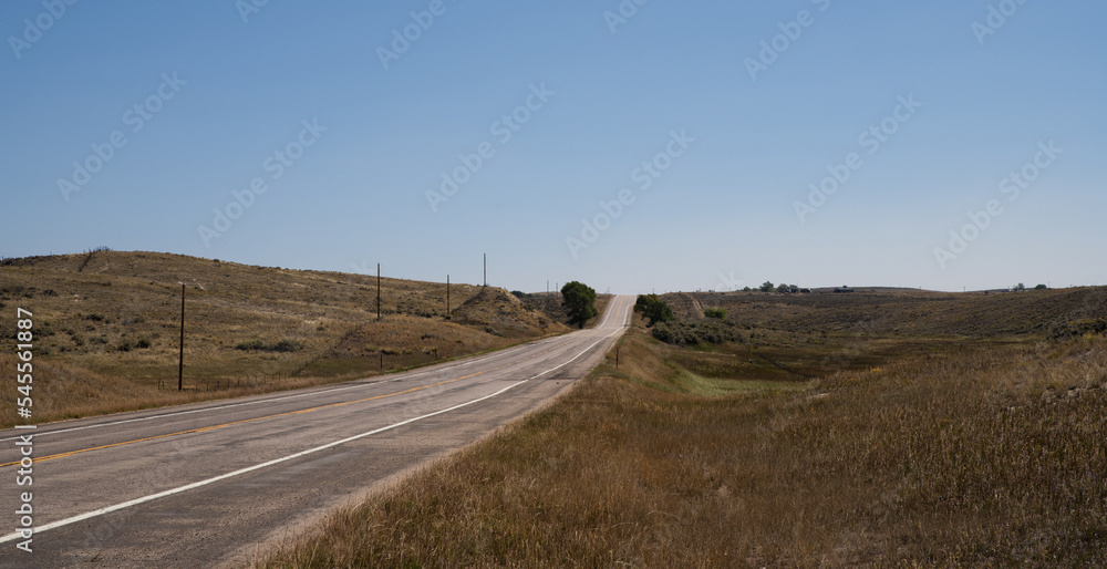 Open road in the western Colorado. No cars, blue skies Open road in the western Colorado. No cars, blue skies
